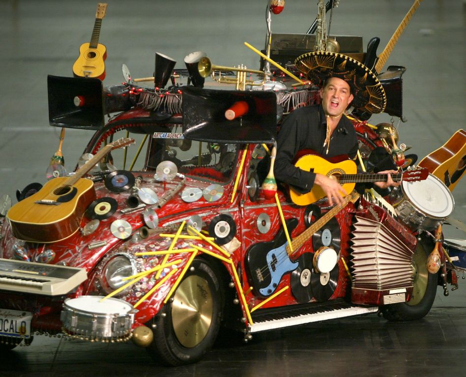 Blank leans out the window of 'Pico de Gallo,' the second Volkswagen Beetle he turned into an art car. AP Photo/Martin Meissner